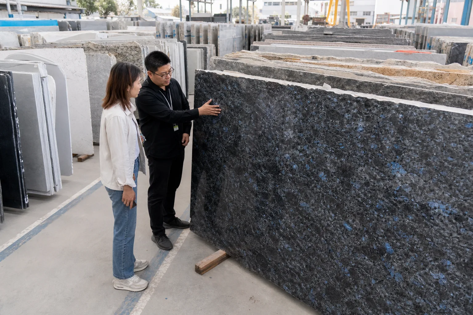 Granite slabs and stone samples displayed across a Xiamen trade hall