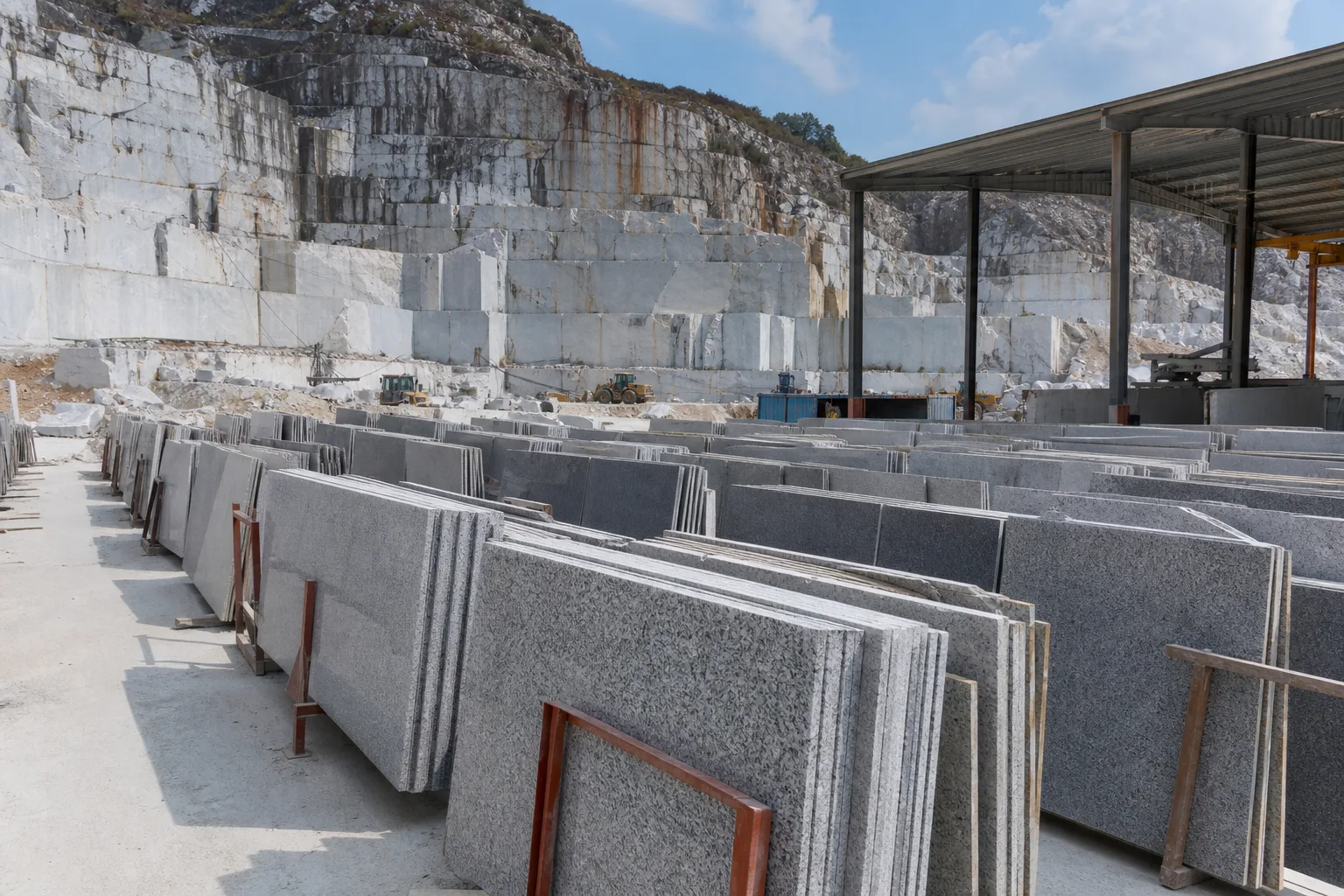 Granite slabs and cut stone arranged inside a Chinese processing yard
